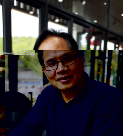 A person wearing glasses and smilingAI-generated content may be incorrect.